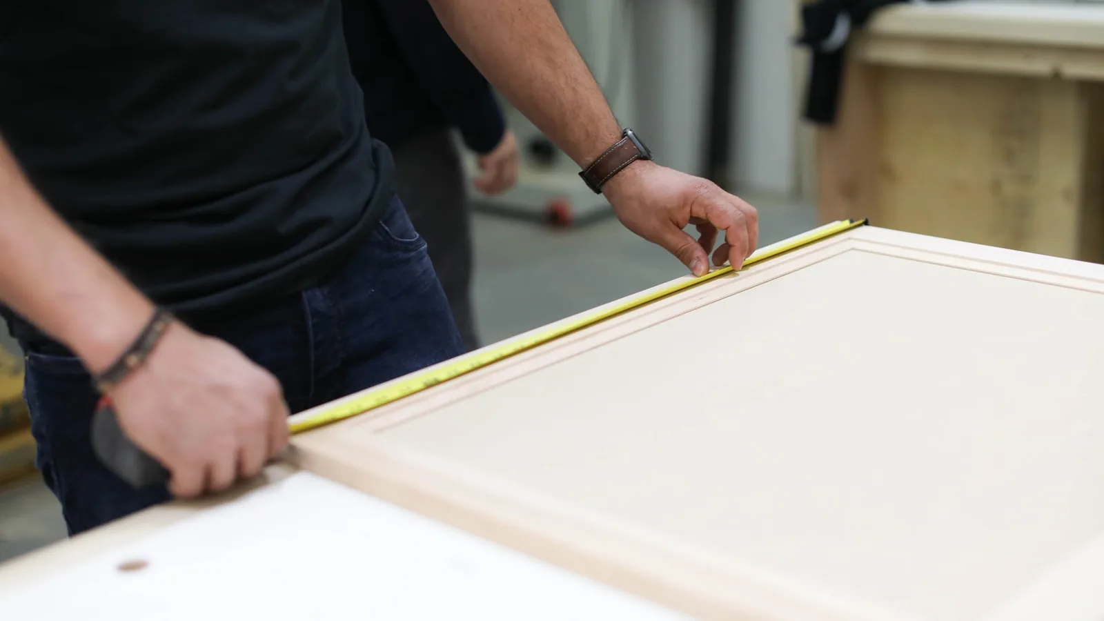Knight carpenter measuring a custom cabinet panel